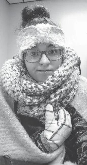  ?? REBECCA MILLER ?? Rebecca Miller, an academic adviser at Tennessee State University, wears sweaters, a scarf, ear coverings, gloves and a blanket over her lap while she works at her desk in Holland Hall on campus in Nashville.