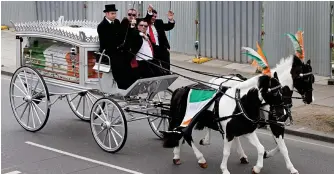  ??  ?? Irish pride: Flag-coloured coffin is carried by horse and carriage yesterday