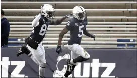  ?? BARRY REEGER – FOR THE ASSOCIATED PRESS ?? Penn State wide receiver Jahan Dotson, right, celebrates after returning a punt for a touchdown during the third quarter Saturday. The host Nittany Lions defeated Michigan State for their third straight win.