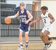  ?? Steven Eckhoff ?? Unity Christian’s Austin Wilkerson battles in the offensive end against Pepperell’s DJ Rogers during a game Dec. 29.