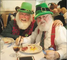  ?? Photo by Ernest A. Brown ?? Bob Murphy, of East Providence, left, and friend Ron Pynn, of Bellingham, dressed properly for the occasion, enjoy the eighth annual St. Patrick’s Day luncheon complete with traditiona­l corned beef and cabbage dinner and an old fashioned Irish...