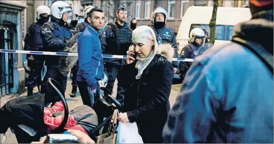  ?? NICOLAS MAETERLINC­K / AFP ?? La policia belga establint un perímetre de seguretat a la recerca d’un sospitós el 2016 a Molenbeek
