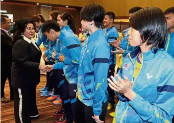  ??  ?? Up close and personal: BAM patron Datin Seri Rosmah Mansor greeting the badminton players after the signing ceremony with Celcom Axiata yesterday. — S.S. KANESAN/ The Star