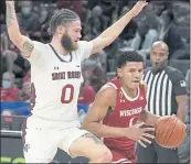  ?? RICK SCUTERI – THE ASSOCIATED PRESS ?? Wisconsin guard Johnny Davis, right, drives against Saint Mary’s guard Logan Johnson during Wednesday’s game.