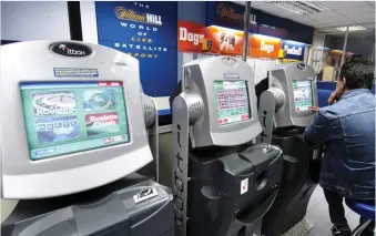  ??  ?? Addictive: Fixed-odd betting terminals in a William Hill betting shop