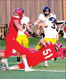  ??  ?? Farmington Senior Colton Kilgore (6-1, 210), shown tackling Prairie Grove fullback Foster Layman during a 27-7 win to open Cardinal Stadium on Sept. 6, became an All-State selection while playing both ways as a twoway starter at middle linebacker and on the offensive line. Kilgore had 41 solo tackles and 26 assists for 67 total tackles with 6 tackles behind the line of scrimmage.