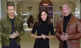  ??  ?? Beneath the beaming smiles … Ryan Reynolds, Gal Gadot and Dwayne Johnson in the Netflix promo video. Photograph: Netflix/YouTube