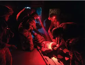  ?? (AP/Mstyslav Chernov) ?? Ukrainian paramedics from the 3rd Assault brigade attend to a soldier wounded during battles in Andriivka near Bakhmut, Ukraine, on Sept. 12.