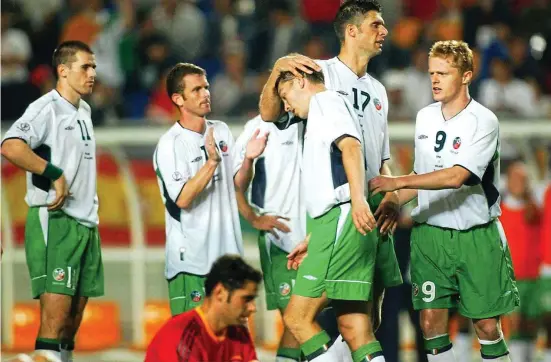 ??  ?? So close: Damien Duff (far right) and Niall Quinn console David Connolly after his penalty shootout miss against Spain in 2002