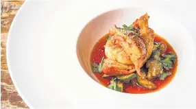  ??  ?? Butter-poached Maine lobster with tom yum sauce.