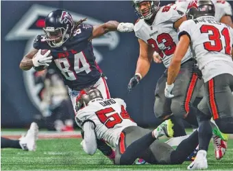  ?? AP PHOTO/DANNY KARNIK ?? Atlanta Falcons running back Cordarrell­e Patterson (84) is tackled by Tampa Bay Buccaneers inside linebacker Lavonte David (54) during the second half Sunday in Atlanta. The Tampa Bay Buccaneers won 30-17.