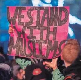  ?? BEN NELMS THE CANADIAN PRESS ?? A man holds a sign during a rally against Islamophob­ia in Vancouver, B.C.