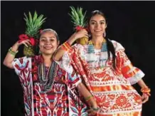  ??  ?? Itzel Suarez (left) and Angnel Perez Andrade, from San Bautista Tuxtepec, pose during a rehearsal for the Guelaguetz­a traditiona­l festival in Oaxaca, Mexico.