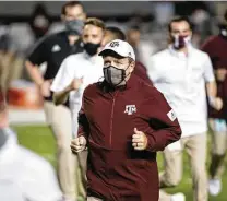  ?? Sean Rayford / Associated Press ?? Coach Jimbo Fisher said he’d rely on someone to relay him the news, but he had to be happy with A&M’s No. 5 CFP ranking.