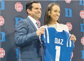  ?? AARON BEARD/AP ?? Duke head football coach Manny Diaz holds a jersey with Duke athletic director Nina King on Dec. 9 in Durham, N.C. Duke announced Diaz’s hiring on Dec. 7.
