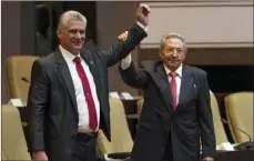  ?? IRENE PEREZ/CUBADEBATE VIA AP ?? Cuba’s new president Miguel Diaz-Canel (left) and former president Raul Castro, raise their arms after Diaz-Canel was elected as the island nation’s new president, at the National Assembly in Havana, Cuba, on Thursday.