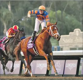  ?? Frederic J. Brown AFP/Getty Images ?? JOCKEY IRAD ORTIZ JR. rides Vino Rosso to victory in the Breeders’ Cup Classic, the final race of the two-day event at Santa Anita. McKinzie finished in second, 41⁄4 lengths behind.