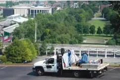  ??  ?? A flatbed truck hauling the statues of Nathan Bedford Forrest, David Glasgow Farragut and Albert Gleaves makes its way to the Tennessee State Museum from the State Capitol on Friday.