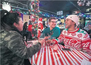  ?? RICHARD LAUTENS TORONTO STAR ?? Melissa Contreras, left, joins Tim Krizner and Bruce Mayers for a drink at the pop-up bar Miracle on Queen St.