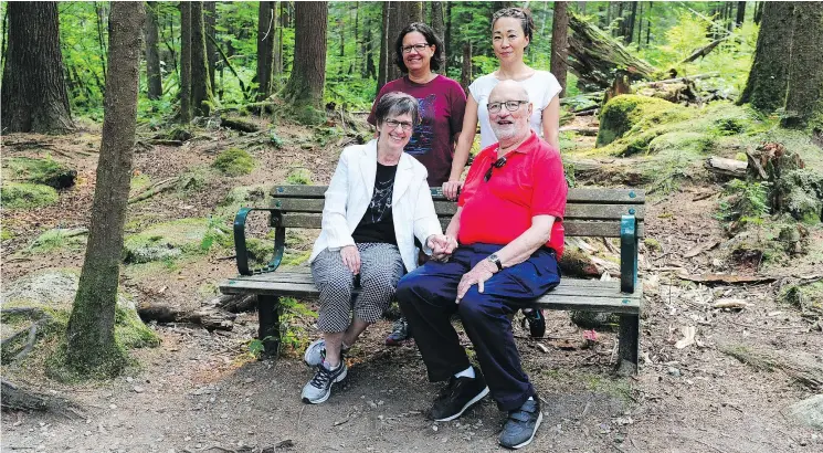  ??  ?? The family of Ben Mostardi — Judy and Stephen Mostardi (sitting) and Kim Mostardi, top left, and Maria Slichter, right — at the Memorial Bench named in his honour on the Varley Trail.