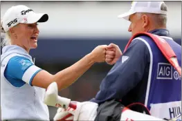  ?? ANDREW REDINGTON — GETTY IMAGES ?? Charley Hull of England fist-bumps her caddie after finishing Saturday's round of the AIG Women's Open at Walton Heath Golf Club in Tadworth, England.