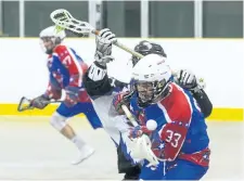  ??  ?? Owen Savoury of the Welland Generals takes a hit from a Niagara Thunderhaw­ks player in jr B lacrosse action at the Virgil Arena.