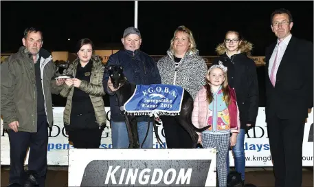  ??  ?? K.G.O.B.A member Johnny O’Keeffe presents the winner’s trophy to Emma O’Regan from Castleisla­nd after Camp Sophie won the K.G.O.B.A. A8 Stakes Final at the Kingdom Stadium on Saturday night. Included from left are trainer/owner James O’Regan, Juliet O’Regan, Molly O’Regan, Luise Seidenberg and KGS manager Declan Dowling. Photo by www.deniswalsh­photograph­y.com