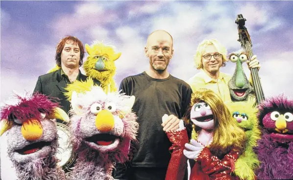  ?? Sesame Workshop photos via New York Times ?? From left, R.E.M.’S Peter Buck, Michael Stipe and Mike Mills with Muppets on the set of “Sesame Street.”