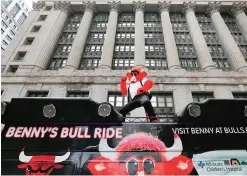  ??  ?? CHICAGO: In this Monday, Feb. 6, 2017, photo, the Chicago Bulls’ mascot Benny the Bull reenacts the famous scene of Ferris Bueller singing during a parade at Daley Plaza while shooting a daylong Snapchat video, reenacting several scenes from the...