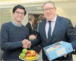  ?? Picture: TIM CLARKE ?? Giles Sheldrick, right, presents cake to Public Health England staff