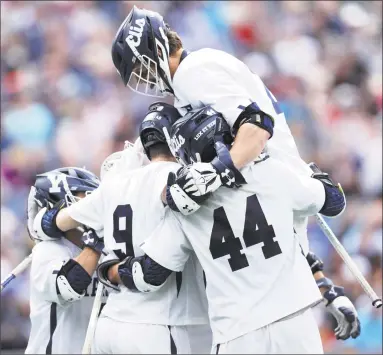  ?? Maddie Meyer / Getty Images ?? Yale’s Lucas Cotler celebrates with teammates after scoring a goal against Duke during Monday’s NCAA men’s lacrosse championsh­ip at Gillette Stadium in Foxborough, Mass.