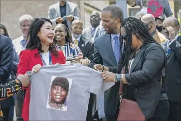  ?? Photograph­s by Mel Melcon Los Angeles Times ?? HYEPIN IM, left, president of Faith and Community Empowermen­t, receives a shirt with an image of Latasha Harlins from Shinese Harlins-Kilgore, Latasha’s cousin, at Florence and Normandie avenues.