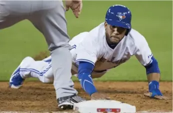  ?? PETER POWER/THE CANADIAN PRESS ?? Blue Jays rookie Devon Travis has shown veterans he knows his place, and everyone seems to agree it’s at second base in the major leagues. Travis drove in the Jays’ only run on Monday.