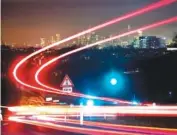  ?? AP PHOTO/MICHAEL PROBST ?? A long exposure photo shows car lights of commuters driving to the city of Frankfurt, Germany, on Tuesday.