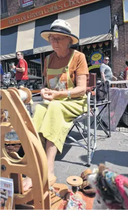  ?? MICHAEL ROBAR/THE GUARDIAN ?? Faith Drinnan caught a moment between talking to people to focus on spinning wool during her last day in the Tour de Fleece at the Downtown Charlottet­own Farmer’s Market on Sunday.