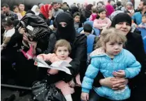  ??  ?? Syrian families await their turn to register at the UN High Commission­er for Refugees (UNHCR) centre in Tripoli, Lebanon, on Thursday.