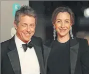  ??  ?? Hugh Grant (left) wore a black suit to the event while his girlfriend, Anna Eberstein, was seen in a black dress and blazer