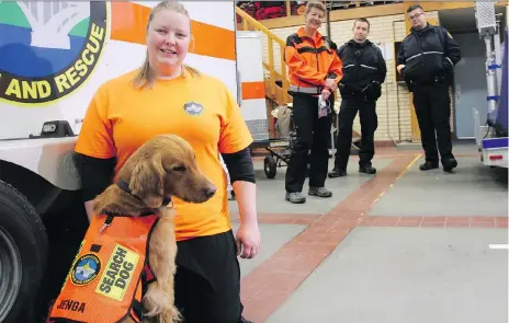  ?? MORGAN MODJESKI ?? Kate Dean, a member of Saskatoon Search and Rescue and a civilian dog trainer, stands with her three-year-old golden retriever, Jenga, at the city’s York Avenue fire station on Wednesday. After two years of training, Jenga is now certified to work in search and rescue operations.