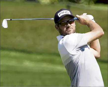  ?? Ap PHOTOS ?? corey conners hits from the 16th fairway during the second round of the arnold palmer invitation­al on friday in Orlando, fla. Below, rory Mcilroy chips to the 16th green.