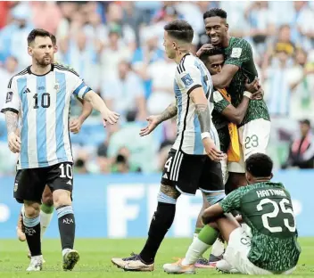  ?? Picture: GETTY IMAGES/CLIVE BRUNSKILL ?? THIS HURTS: Lionel Messi and Enzo Fernandez of Argentina look dejected while Saudi Arabia players celebrate their 2-1 victory in the Fifa World Cup Qatar 2022 Group C match at Lusail Stadium on Tuesday.