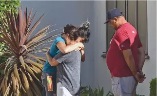  ??  ?? A TRADER JOE’S employee is comforted after a suspect barricaded inside the supermarke­t in Silverlake, Los Angeles, July 21.