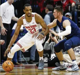  ?? PAUL VERNON / ASSOCIATED PRESS ?? Ohio State forward Keita Bates-Diop (left) drives against Penn State forward Deivis Zemgulis during an NCAA college basketball game this past January in Columbus. Bates-Diop, who averages 19.2 points and 8.9 rebounds per game, won conference player of...