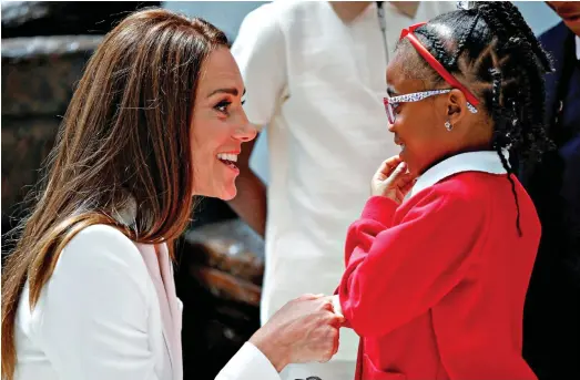  ?? ?? Please to meet you: Kate shakes hands with a young guest at the unveiling of the Windrush memorial in Waterloo
