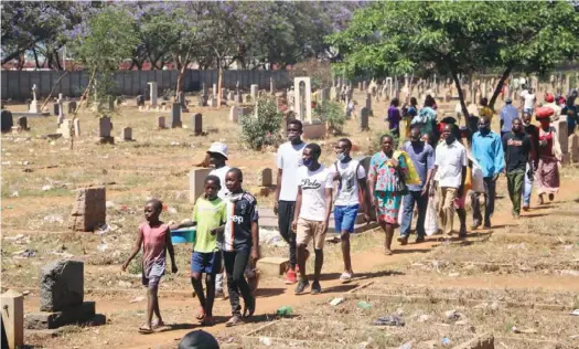  ??  ?? The once-sacred and well-protected Pioneer Cemetery opposite Mupedzanha­mo market in Mbare is now a pale shadow of itself. Part of the perimeter wall came down years ago and City of Harare failed to repair it. The cemetery is now a short-cut for people walking to nearby areas while others now use it as a resting place and playground. Picture: Shepherd Tozvireva