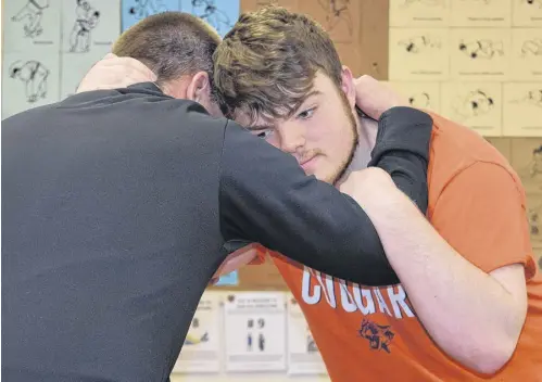  ?? FRAM DINSHAW/TRURO NEWS ?? Learning how to grapple one’s opponent is an essential wrestling skill. Hans Budgey, left, has given Seth Priestatki­nson plenty of coaching in this regard.