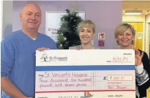  ??  ?? Well Done Phil Steven, presenting the cheque to Laura McDade and Kate Lennon from the hospice