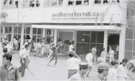  ?? Photograph: Bettmann/Bettmann Archive ?? An anti-communist mob attacking the Res Publica University in Jakarta on 12 October 1965.