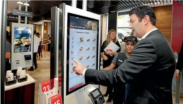  ?? PHOTO: AP ?? McDonald’s introduced self-service kiosks to its restaurant­s in 2015.