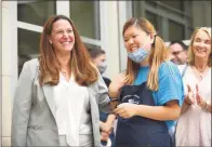  ?? Tyler Sizemore / Hearst Connecticu­t Media file photo ?? Abilis CEO Amy Montimurro, left, in July alongside Michelle Yoon of The Cafe at Greenwich Library. As part of a hiring drive to add more people to help in job coaching and other services offered by the nonprofit, Abilis is running job fairs and affixing vehicles with magnetic placards advertisin­g open jobs.