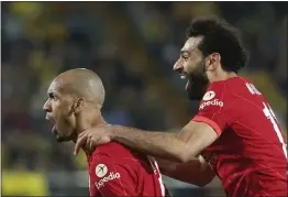  ?? ALBERTO SAIZ — THE ASSOCIATED PRESS ?? Liverpool's Fabinho, left, celebrates after scoring his side's opening goal during a Champions League semifinal between Villarreal and Liverpool at the Ceramica stadium in Villarreal, Spain, on Tuesday.